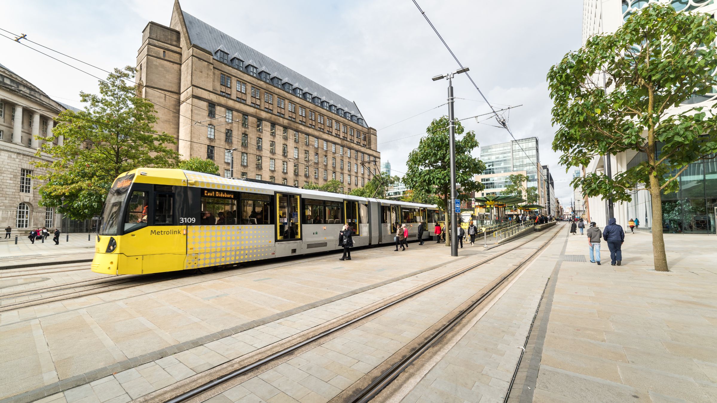 People waiting for a tram in a street