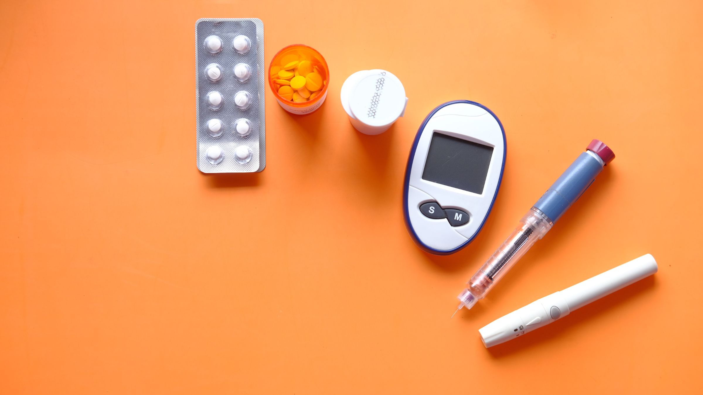 Image of diabetic management tools and medications laid out