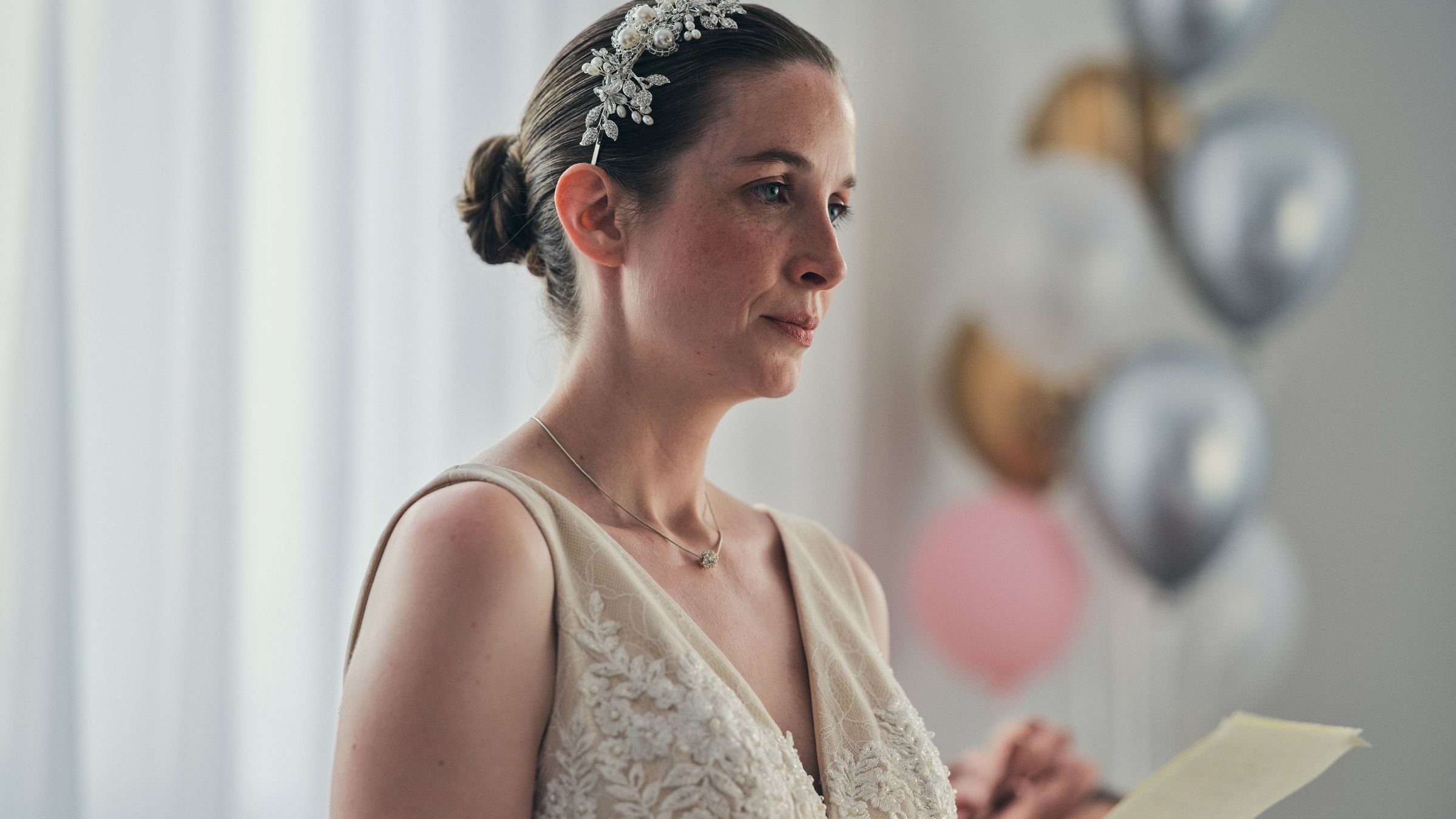 Bride looking sad reading letter from her deceased father.